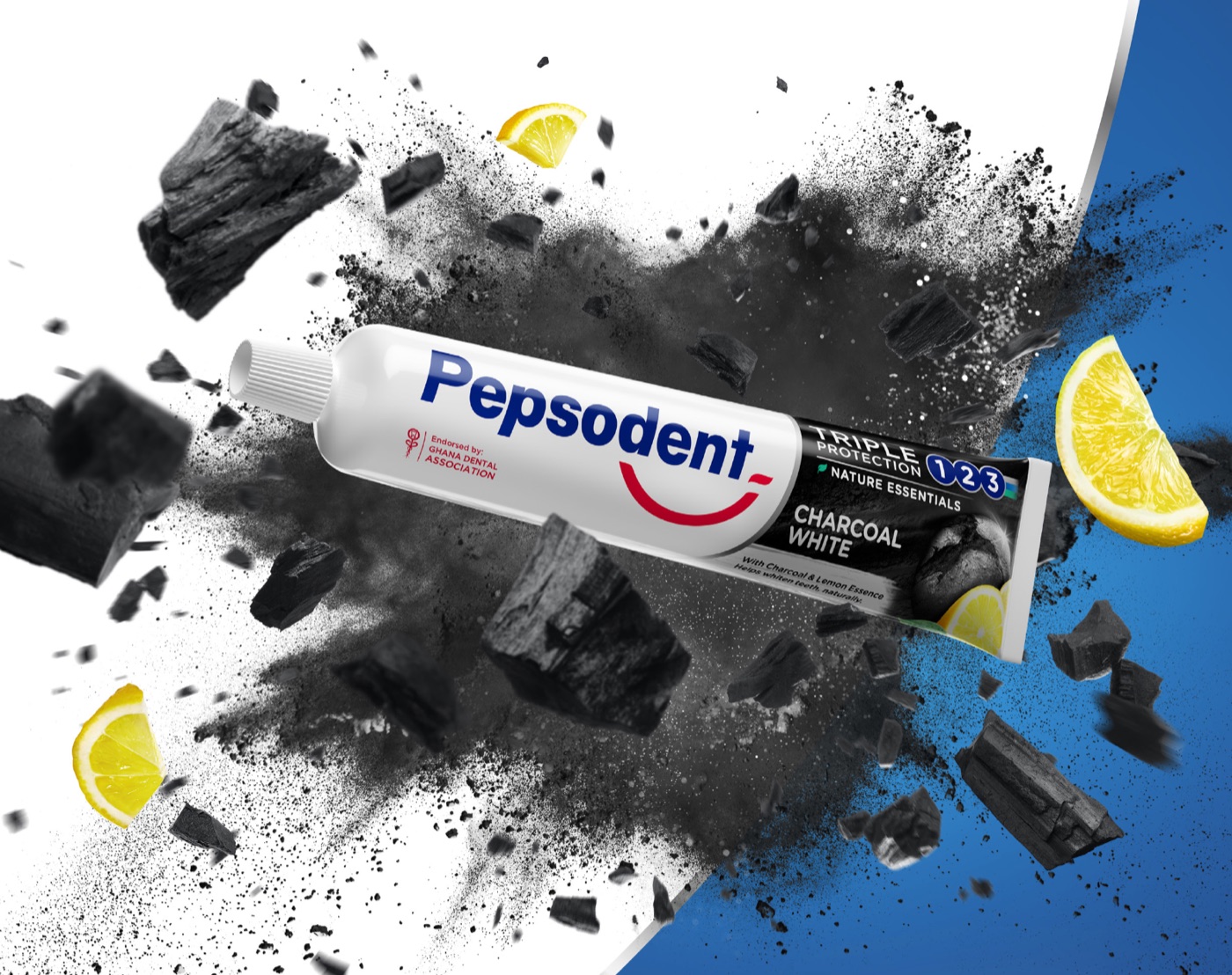 Pepsodent Charcoal White key visual: the tube bursting through charcoal dust with lemon slices